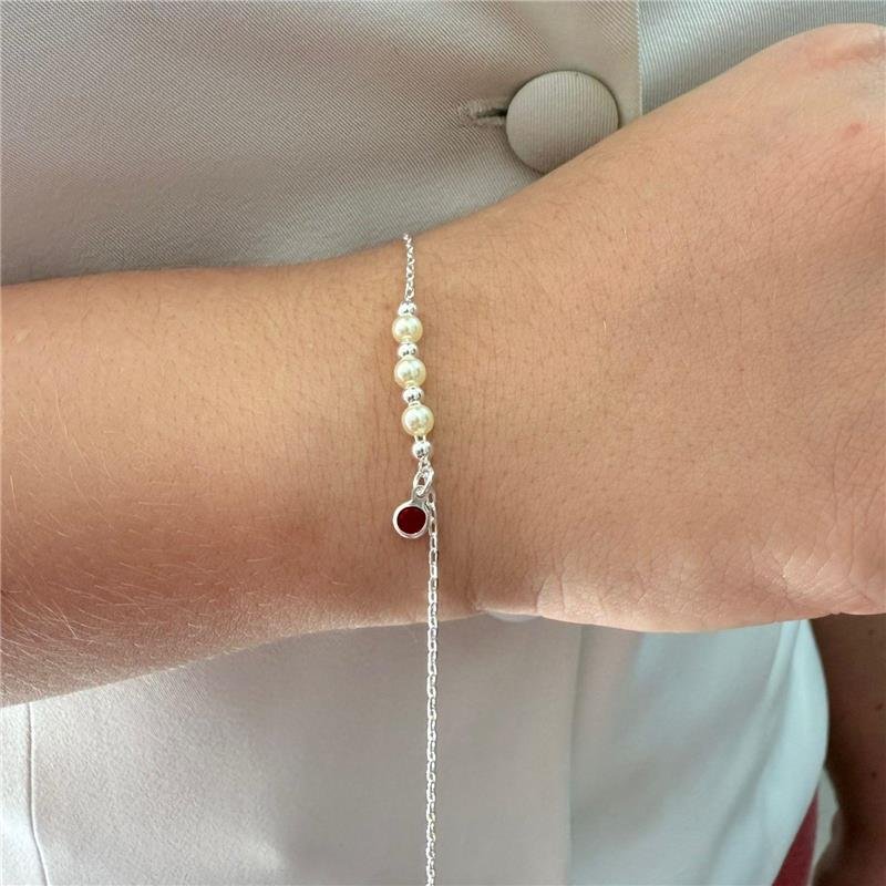 PULSEIRA PÉROLA COM PONTO DE LUZ VERMELHO